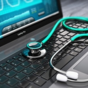 nurse's stethoscope on computer keyboard with a webinar on the screen